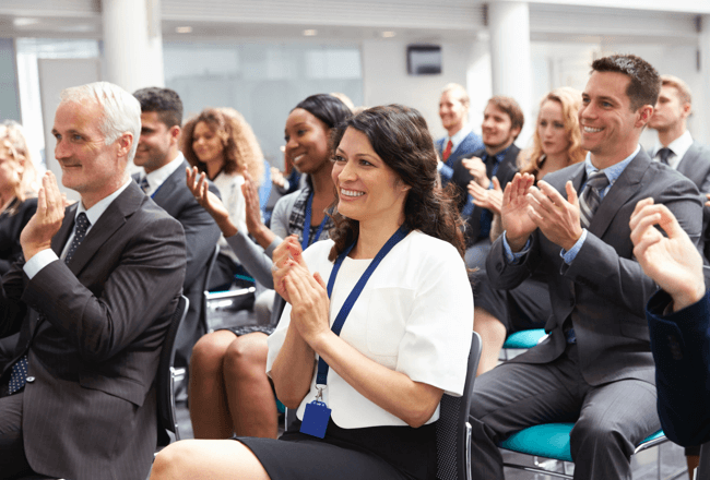 Group of people applauding at a healthcare compliance auditing conference