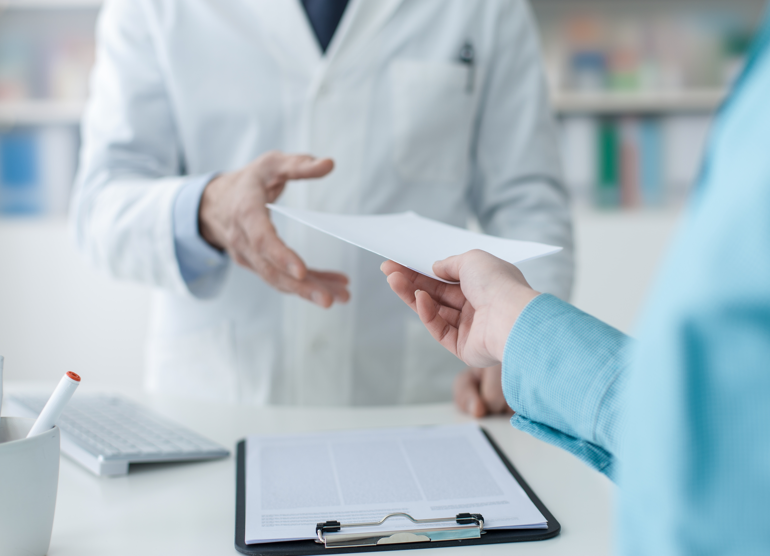CMS Part C&D Data Validation 1 person handing another person a piece of paper referring to a cms data validation audit